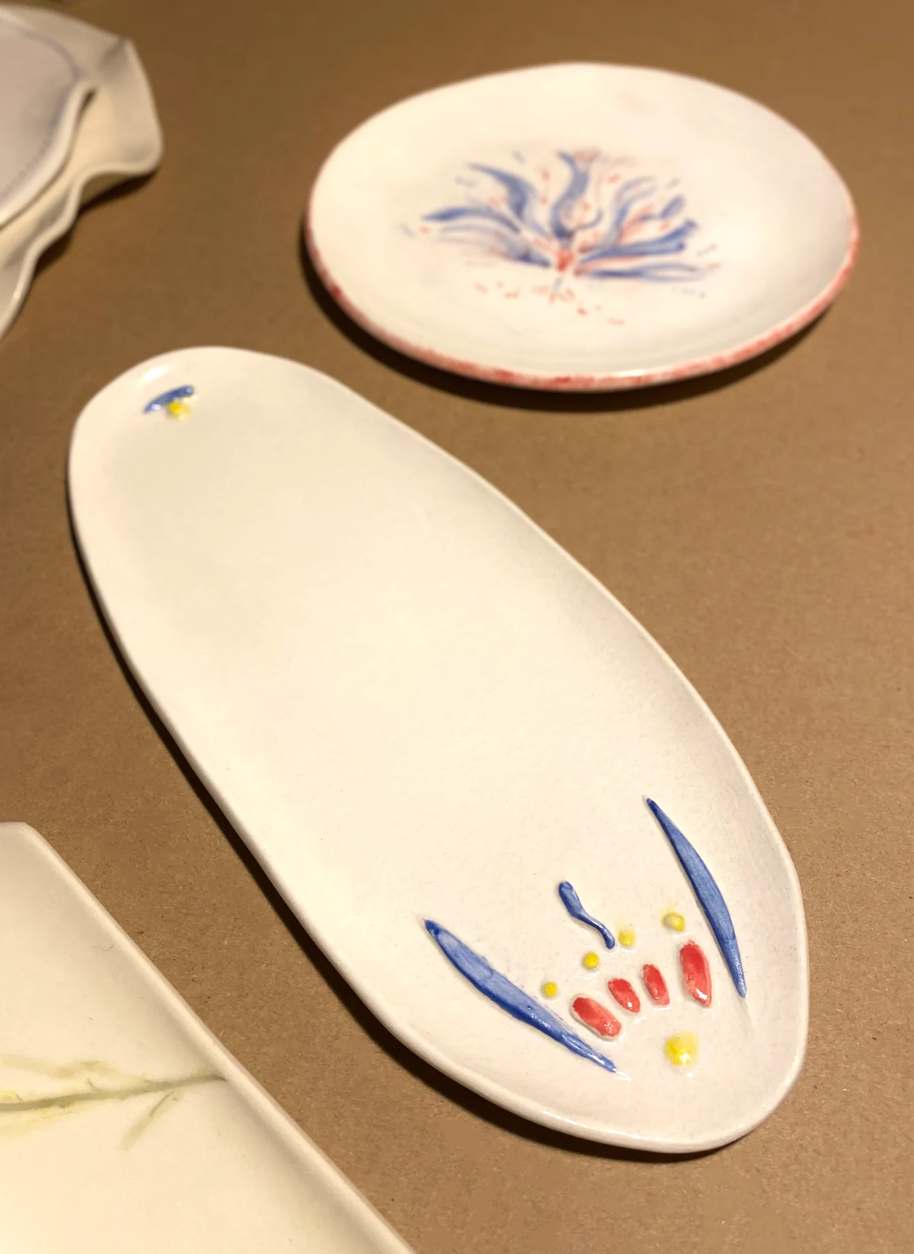 Oval and round plates with colourful floral details